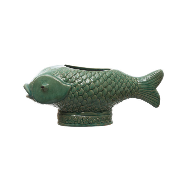 A turquoise debossed stoneware fish planter with a reactive glaze.